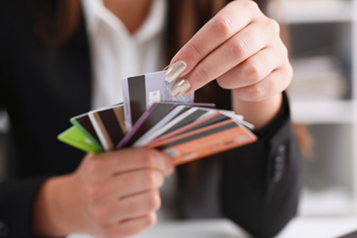 Woman fanning out stack of gift cards