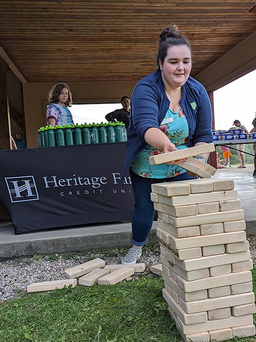A Heritage Family volunteer plays an extra large block tower game at Bennington's National Night Out