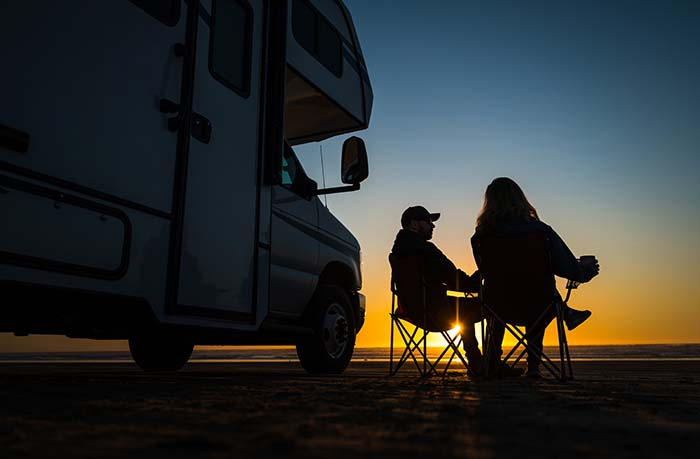 Couple Relaxing Near Their RV