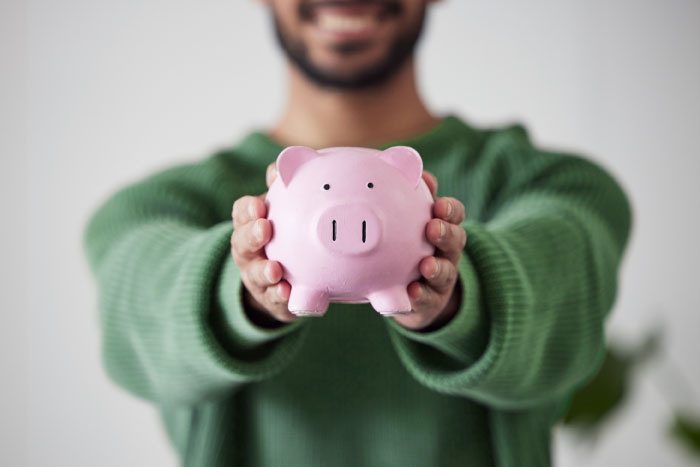 Person holding a piggy bank