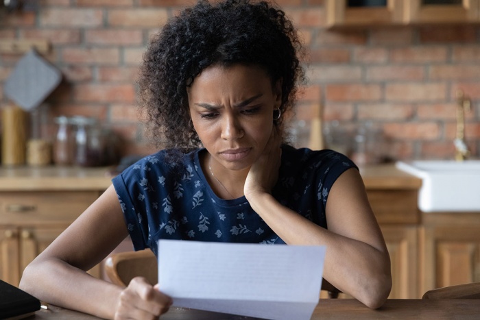 unhappy woman reading letter