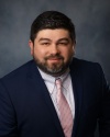 A smiling man, Jerry DePhillips, in a business suit